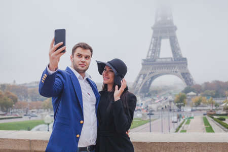 couple of tourists taking photo with Eiffel Tower in Paris, selfie, tourism in Europe, Franceの写真素材