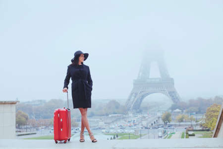 tourist in Paris, Europe tour, woman with luggage near Eiffel Tower, Franceの写真素材