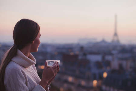 travel to Paris, woman looking at Eiffel tower and beautiful panorama of the cityの素材 [FY31077018096]