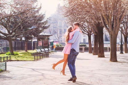 dating, happy young girl hugging her boyfriendの写真素材