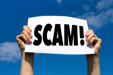 scam concept sign, hands holding white paper with message text alert