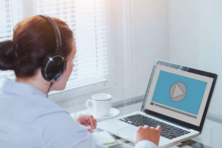 woman watching video tutorial on computer, business education online, multimediaの写真素材