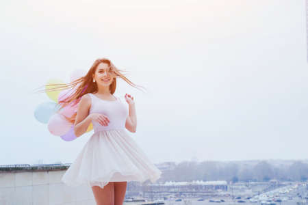 happy summer young girl with colorful balloonsの写真素材