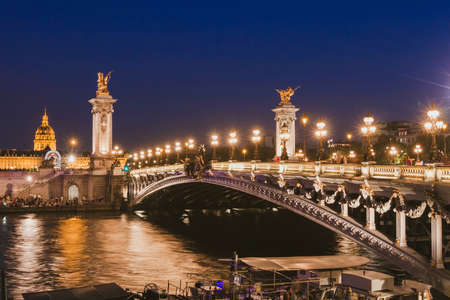 Paris by night, beautiful illumination of Alexandre III bridge on Seine river in the evening, historical architectureの写真素材