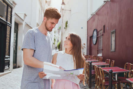 couple of tourists looking at the map on the streetの写真素材