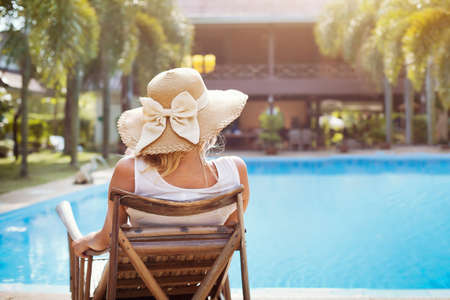 summer holidays in luxury hotel, woman relaxing near beautiful swimming poolの写真素材