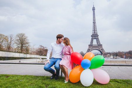 photo shoot, happy couple with balloons posing near Eiffel tower in Paris