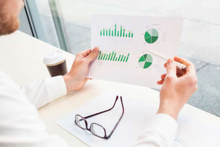 businessman analizing financial report, close up of handsの写真素材