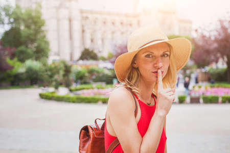 secret concept, finger on the lips, portrait of woman travelingの写真素材