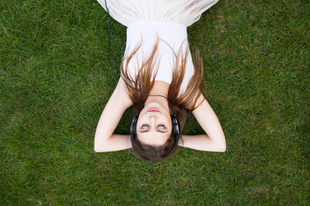 young woman enjoying music in headphonesの写真素材