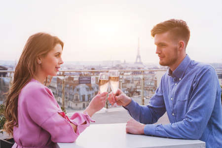 romantic dinner for couple in luxurious restaurant in Paris with panoramic city view and Eiffel towerの写真素材