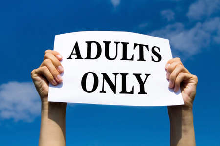 adults only, concept, photo of hands holding paper signの写真素材