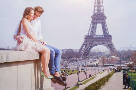 romantic love, affectionate couple sitting near Eiffel Tower in Paris, honeymoon in Europeの写真素材