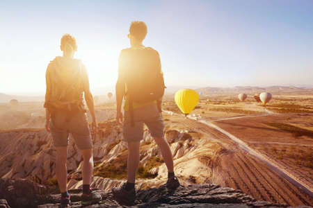 travel background, couple of travelers looking at the panoramic spectacular beautiful  view of mountains in Cappadocia, outdoor sport and hikingの写真素材