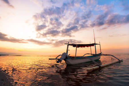 sunset on the beach in Bali, traditional fisherman boat in Indonesia, Lovinaの写真素材