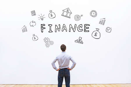 finance concept, business man looking at drawn word on white backgroundの写真素材
