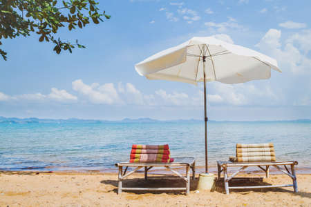 beach tourism, two deck chairs and umbrella near the seaの写真素材