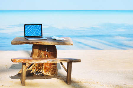 office of freelancer on the beach, laptop computer with empty screen and nobody, freelance conceptの写真素材
