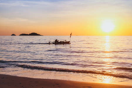 beautiful nature, exotic beach at sunset with silhouette of fisherman boat, inspiring tropical landscape background with copy spaceの写真素材