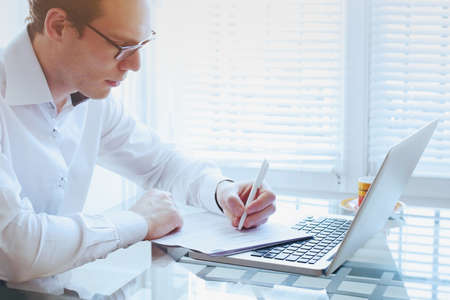 business man working in the office with computer and documentsの写真素材