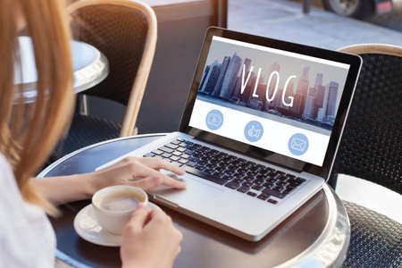 video blog, woman reading vlog online on computerの写真素材