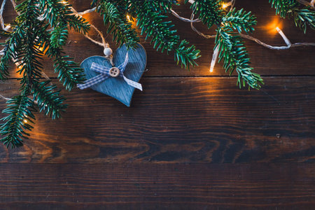 christmas background with blue wooden heart and fir tree