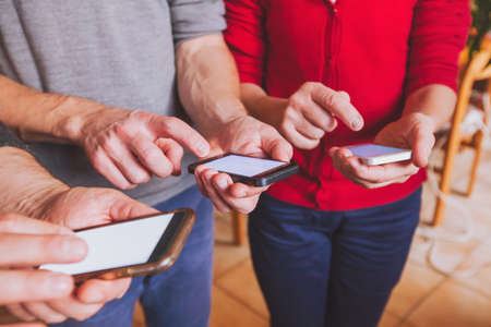 hands of people using smartphones, online communication or social network conceptの写真素材