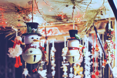 snowman toy decoration in christmas market in european city by nightの写真素材