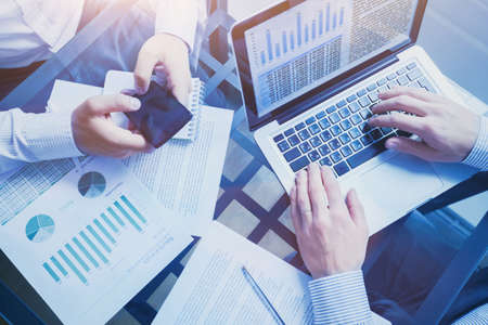 business intelligence concept, team of people working on charts and data, meeting in the office, graphs analysisの写真素材