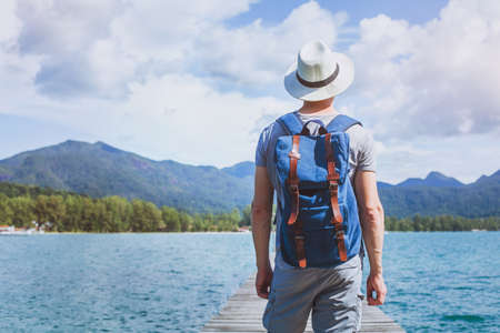 wanderlust travel, young tourist traveler with backpack ready for summer beach outdoor adventureの写真素材