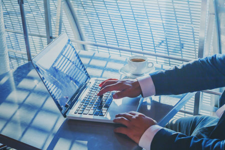 banking or shopping online, e-commerce concept, closeup of hands of businessman working on computer, writing email to customer, business man executive typing on keyboardの写真素材