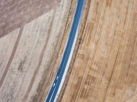 aerial view of asphalt road from drone, top down of two cars driving, geometry landscapeの写真素材