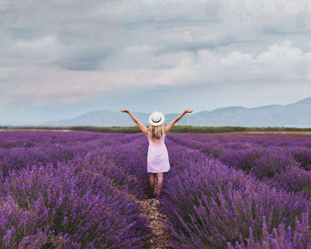 inspiration and creativity concept, woman in inspiring landscape of lavender fields in Franceの写真素材