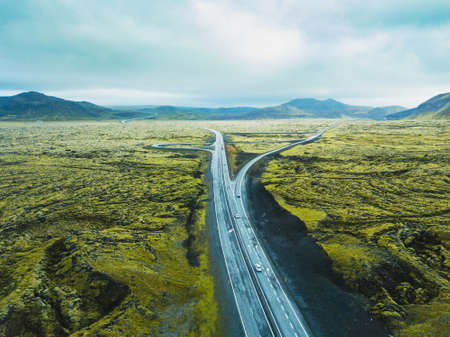 aerial landscape of Iceland, drone view of highway road in green volcanic fieldsの写真素材