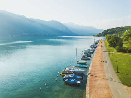 aerial landscape of Annecy lake, Alps, France, yachts and sailing boats from above, pedestrian walk near crystal blue waterの写真素材