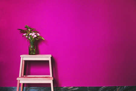 pink color in interior design decoration, painted wall and vase with flowersの写真素材
