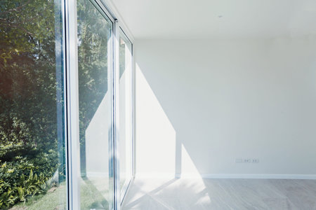 empty sunny room interior with white painted wall, big window and modern wooden floor parquet, new...