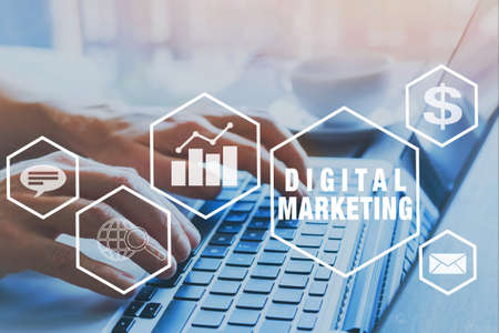 digital marketing icons, hands typing on keyboard as backgroundの写真素材