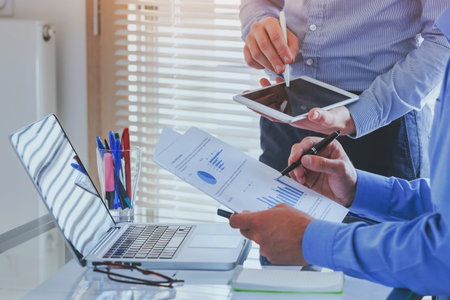 financial charts and graphs analytics, ROI, business people working on monthly report in startup...