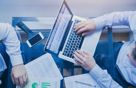 business management, top view of hands of businessmen working on computer on tableの写真素材