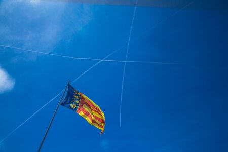 Catalonia flag in Valencia, Spain on the blue sky backgroundの写真素材