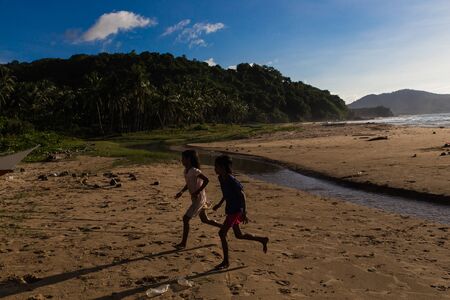 EL NIDO, PALAWAN / PHILIPPINES - JANUARY 1, 2018 : group of children playing catch up in wild Safari beach in El Nido, Palawan, Philippinesのeditorial素材