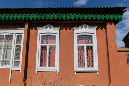 KARAKOL, KYRGYZSTAN - MARCH 3, 2020: old traditional russian style wooden and brick house near Issyk Kulのeditorial素材