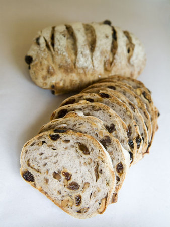 Sliced traditional golden brown sultana bread loaf.