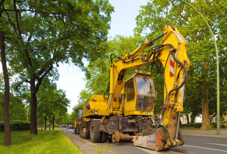 Hydraulic concrete breaker parked on a residential  road. A 8 weeler dump truck is equipped with concrete breaker.の写真素材