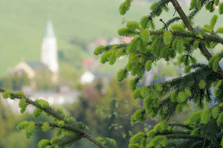 Spring in the mountains with rural houses and a local church within out of focus area.  Resort Oberwiesenthal, Saxony, Germany, a crossing point into Czech Republic.の写真素材
