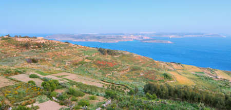 Gozo island terrain from the hill top. View towards Malta and Comino across the Passの写真素材