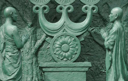 Two praying men and a lotus flower; detail from Buddha statue at Toganji Temple Nagoya, This impressive statue is 15 meters high and dates back to the sixteenth centuryの写真素材