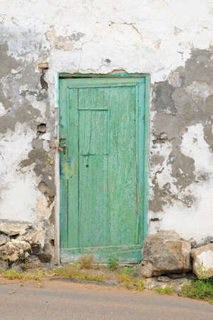 An old door with peeling paint; Haria, central Lanzarote, Canary islands, Spainの写真素材