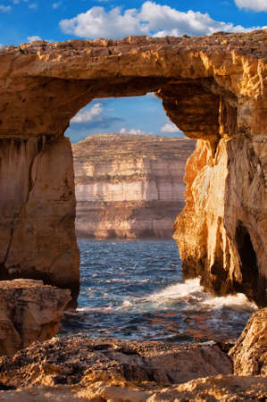 Azure window, natural stone arch by Dwejra cliffs at western  Gozo island, Maltaの写真素材